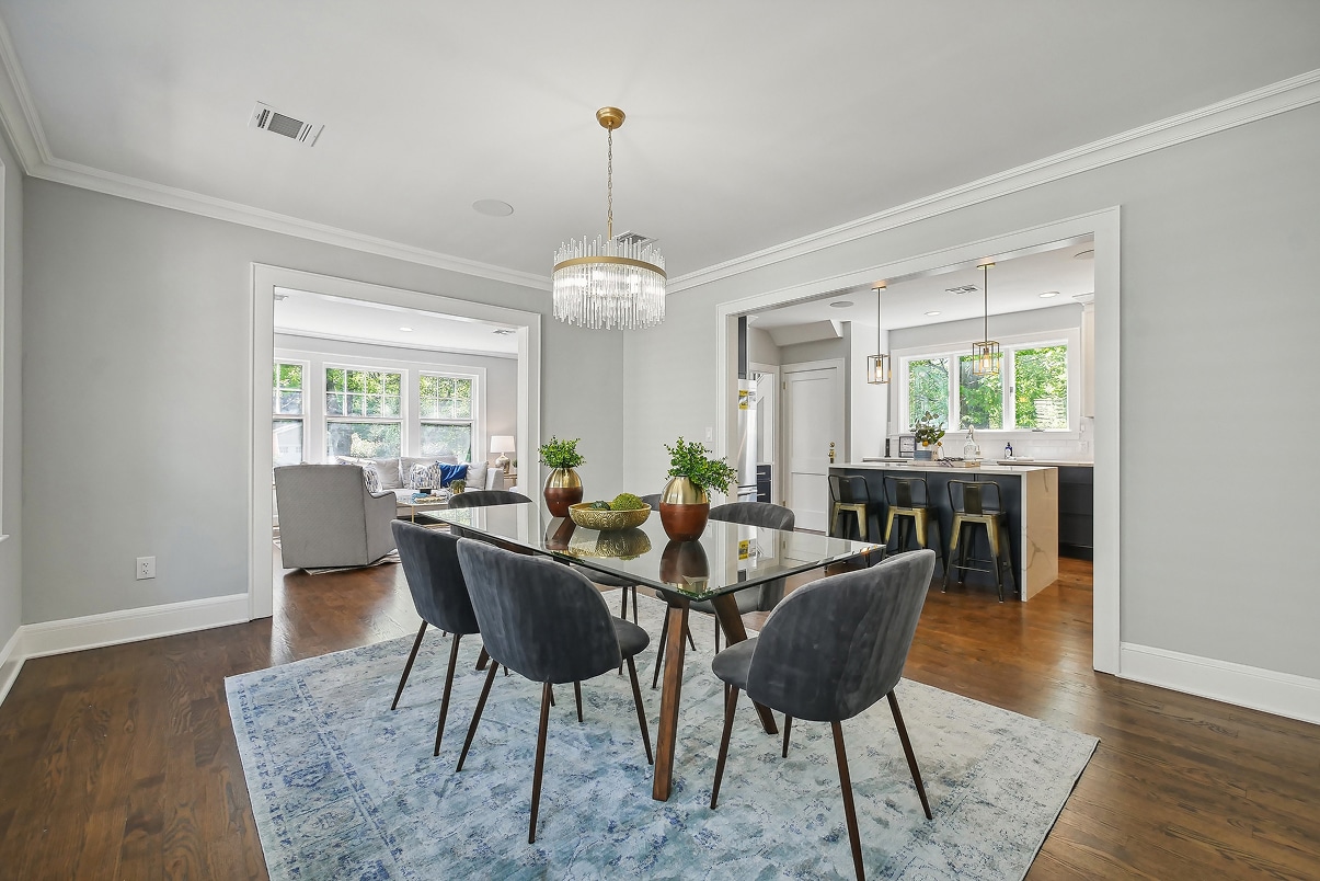 the living room, kitchen and dining room spaces of a new addition to a home