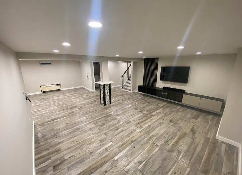 large renovated basement with wood flooring and recessed lighting