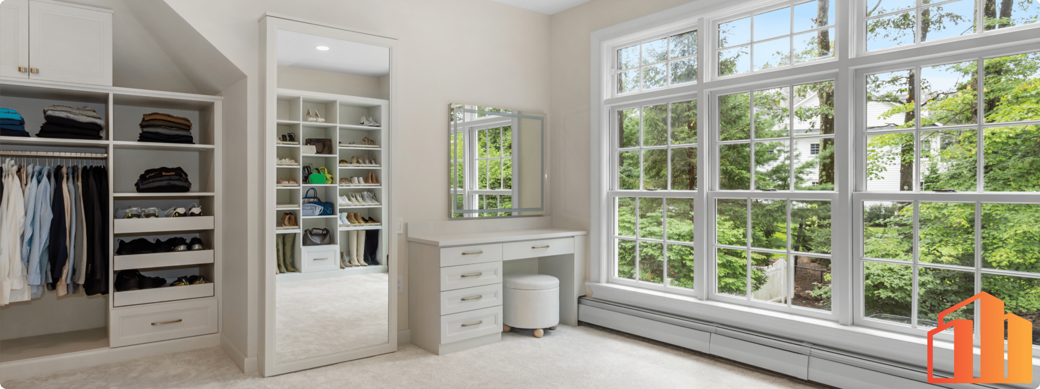 a large custom closet with large windows and storage built-ins